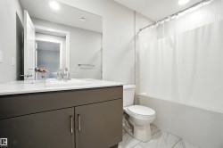 Bathroom featuring shower / bath combination with curtain and vanity - 