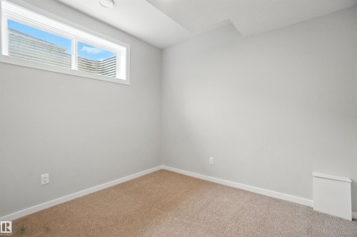 Unfurnished room featuring baseboards and carpet floors - 20727 25 Ave, Edmonton, AB - Indoor Photo Showing Other Room