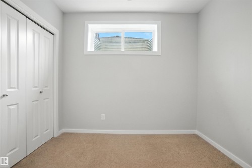 Unfurnished bedroom featuring carpet floors and a closet - 20727 25 Ave, Edmonton, AB - Indoor Photo Showing Other Room