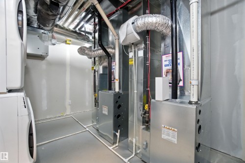 Utility room featuring stacked washer / dryer - 20727 25 Ave, Edmonton, AB - Indoor Photo Showing Basement