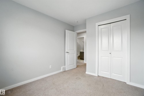 Unfurnished bedroom featuring light colored carpet and a closet - 20727 25 Ave, Edmonton, AB - Indoor