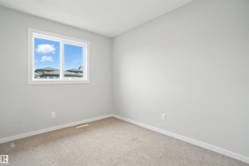 Carpeted empty room featuring baseboards - 20727 25 Ave, Edmonton, AB - Indoor Photo Showing Other Room