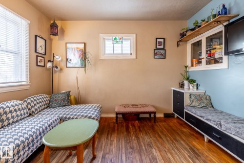 Living area with dark wood-style flooring and baseboards - 11240 84 Street, Edmonton, AB - Indoor Photo Showing Bedroom
