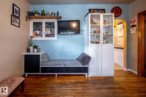 Mudroom featuring arched walkways and dark wood-style floors - 11240 84 Street, Edmonton, AB - Indoor