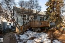 Snow covered rear of property featuring a deck and a shingled roof - 11240 84 Street, Edmonton, AB  - Outdoor With Deck Patio Veranda 