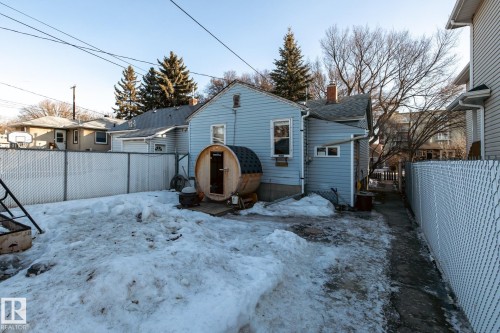 Snow covered rear of property with a fenced backyard, a chimney, and heating fuel - 11240 84 Street, Edmonton, AB - Outdoor