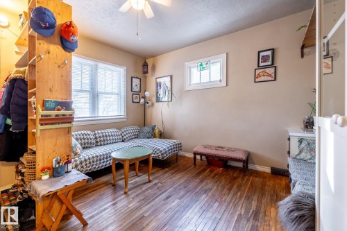 Living area featuring wood-type flooring, a ceiling fan, and a textured ceiling - 11240 84 Street, Edmonton, AB - Indoor