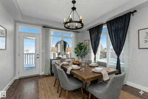 Dining room with a chandelier and dark wood-type flooring - 62 Ellice Bend, Fort Saskatchewan, AB - Indoor Photo Showing Dining Room