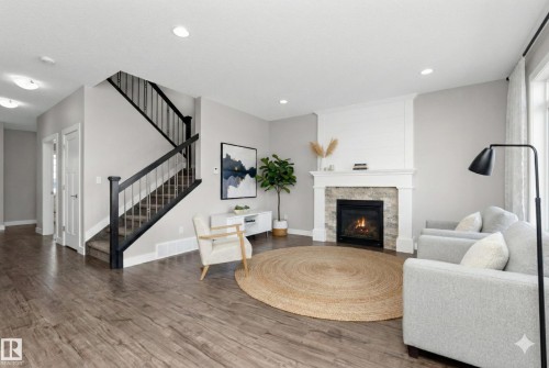 Living area with wood finished floors, a fireplace, and recessed lighting - 62 Ellice Bend, Fort Saskatchewan, AB - Indoor Photo Showing Living Room With Fireplace