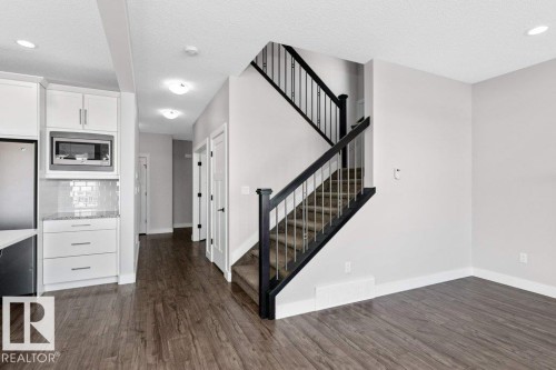 Stairway with wood finished floors, recessed lighting, and a textured ceiling - 62 Ellice Bend, Fort Saskatchewan, AB - Indoor