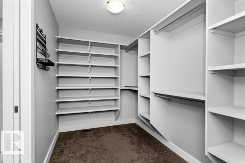 Walk in closet with dark colored carpet - 62 Ellice Bend, Fort Saskatchewan, AB - Indoor With Storage