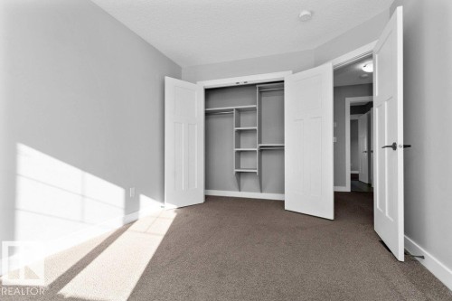 Unfurnished bedroom featuring carpet, a closet, and a textured ceiling - 62 Ellice Bend, Fort Saskatchewan, AB - Indoor Photo Showing Other Room