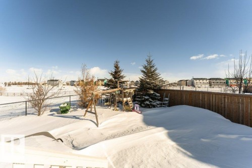 Yard covered in snow featuring a residential view - 62 Ellice Bend, Fort Saskatchewan, AB - Outdoor