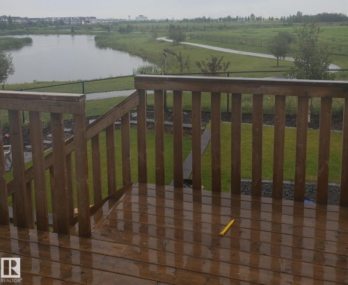 Deck with a lawn and a water view - 62 Ellice Bend, Fort Saskatchewan, AB - Outdoor With View