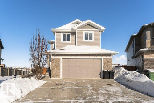 View of front of house with stone siding, an attached garage, and concrete driveway - 62 Ellice Bend, Fort Saskatchewan, AB - Outdoor