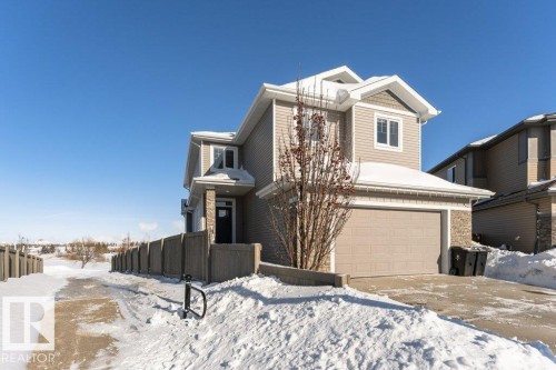 View of front of home with a garage and stone siding - 62 Ellice Bend, Fort Saskatchewan, AB - Outdoor