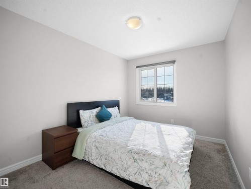 Carpeted bedroom with baseboards - 218 Hawks Ridge Boulevard, Edmonton, AB - Indoor Photo Showing Bedroom