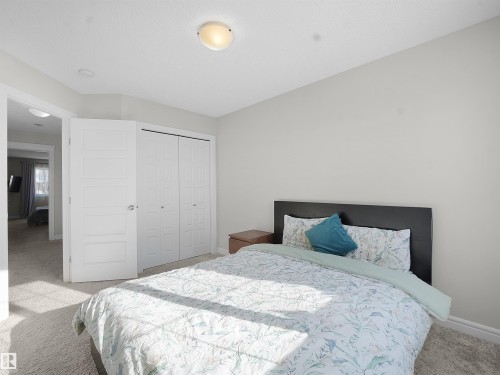 Bedroom featuring light carpet and a closet - 218 Hawks Ridge Boulevard, Edmonton, AB - Indoor Photo Showing Bedroom