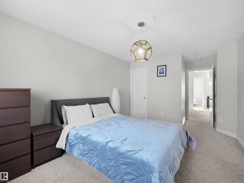Bedroom featuring carpet flooring and a textured ceiling - 218 Hawks Ridge Boulevard, Edmonton, AB - Indoor Photo Showing Bedroom