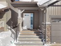 Snow covered property entrance featuring stone siding - 218 Hawks Ridge Boulevard, Edmonton, AB  - Outdoor 