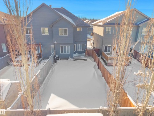 Snow covered property featuring a fenced backyard and a residential view - 218 Hawks Ridge Boulevard, Edmonton, AB - Outdoor