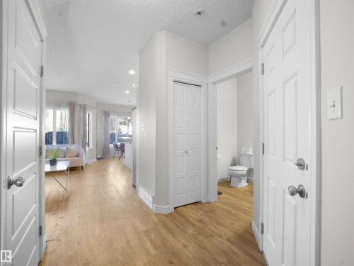 Hall with recessed lighting, light wood-style floors, and a textured ceiling - 218 Hawks Ridge Boulevard, Edmonton, AB - Indoor Photo Showing Other Room