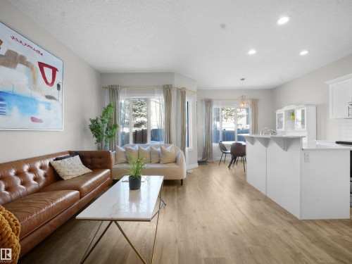 Living room featuring light wood-style flooring, a textured ceiling, and recessed lighting - 218 Hawks Ridge Boulevard, Edmonton, AB - Indoor Photo Showing Living Room