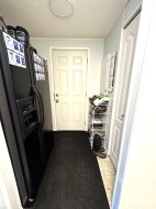 Side entrance featuring a textured ceiling - 