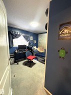 Bedroom featuring carpet and a textured ceiling - 