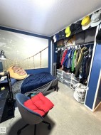 Bedroom with a textured ceiling, carpet, and a closet - 