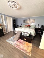 Bedroom featuring vinyl finished floors and a textured ceiling - 