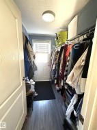 Spacious closet with dark wood-style vinyl floors - 