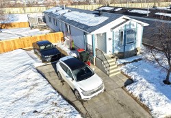 View of snowy exterior featuring a shingled roof - 