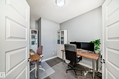 Office with dark wood finished floors and a textured ceiling - 3716 46 Avenue, Beaumont, AB - Indoor Photo Showing Office