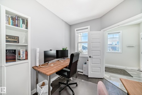 Home office with baseboards and dark wood-type flooring - 3716 46 Avenue, Beaumont, AB - Indoor Photo Showing Office