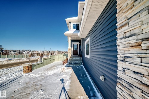 View of home's exterior with a residential view and stone siding - 3716 46 Avenue, Beaumont, AB - Outdoor