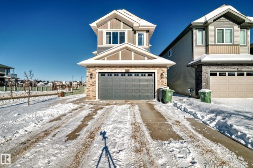 View of front facade featuring stone siding and a residential view - 3716 46 Avenue, Beaumont, AB - Outdoor
