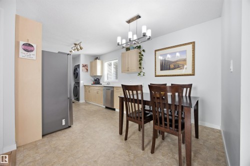 Dining room featuring stacked washer and clothes dryer, light floors, and hanging lights - 2340 30 Avenue, Edmonton, AB - Indoor Photo Showing Dining Room