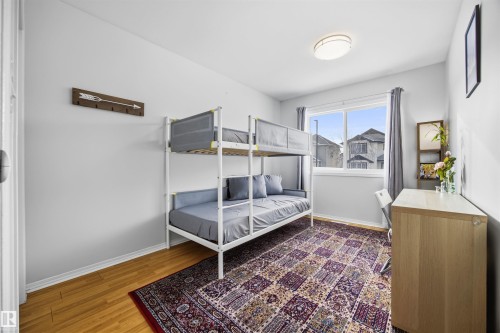 Bedroom with baseboards and dark wood-type flooring - 2340 30 Avenue, Edmonton, AB - Indoor Photo Showing Bedroom