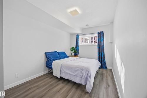 Bedroom with wood finished floors and baseboards - 2340 30 Avenue, Edmonton, AB - Indoor Photo Showing Bedroom