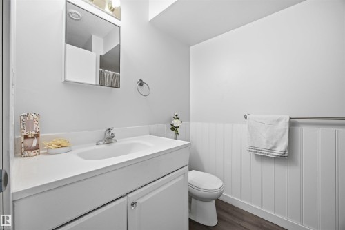 Bathroom with vanity, dark wood-type flooring, wainscoting, and curtained shower - 2340 30 Avenue, Edmonton, AB - Indoor Photo Showing Bathroom