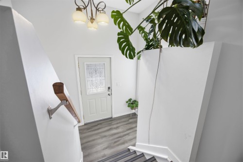 Foyer entrance with suspended lighting and wood finished floors - 2340 30 Avenue, Edmonton, AB - Indoor Photo Showing Other Room