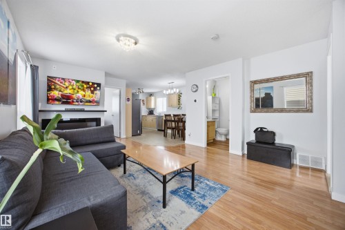 Living room featuring light wood-style floors and suspended lighting - 2340 30 Avenue, Edmonton, AB - Indoor Photo Showing Living Room