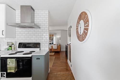 Kitchen with electric stove, tasteful backsplash, a textured ceiling, and gray cabinetry - 18717 57 Avenue, Edmonton, AB - Indoor Photo Showing Kitchen
