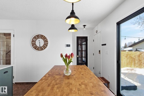 Dining area featuring a textured ceiling - 18717 57 Avenue, Edmonton, AB - Indoor Photo Showing Dining Room
