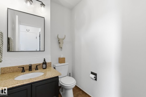 Bathroom featuring vanity and dark tile patterned floors - 18717 57 Avenue, Edmonton, AB - Indoor Photo Showing Bathroom