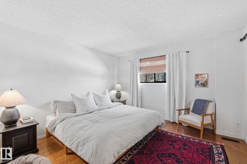 Bedroom with a textured ceiling and wood finished floors - 18717 57 Avenue, Edmonton, AB - Indoor Photo Showing Bedroom