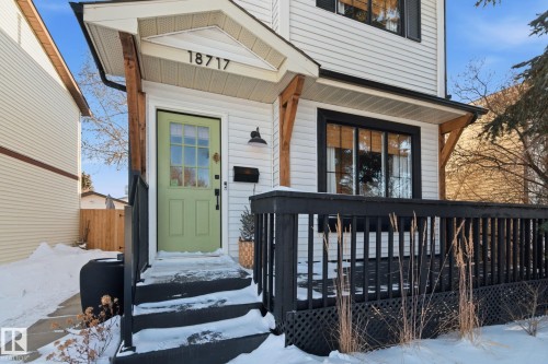 Snow covered property entrance with a wooden deck - 18717 57 Avenue, Edmonton, AB - Outdoor
