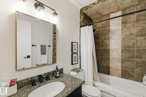 Bathroom with vanity and shower / tub combo - 18717 57 Avenue, Edmonton, AB - Indoor Photo Showing Bathroom
