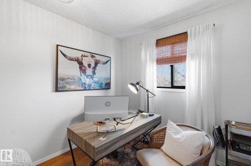 Office space featuring wood finished floors and a textured ceiling - 18717 57 Avenue, Edmonton, AB - Indoor Photo Showing Other Room
